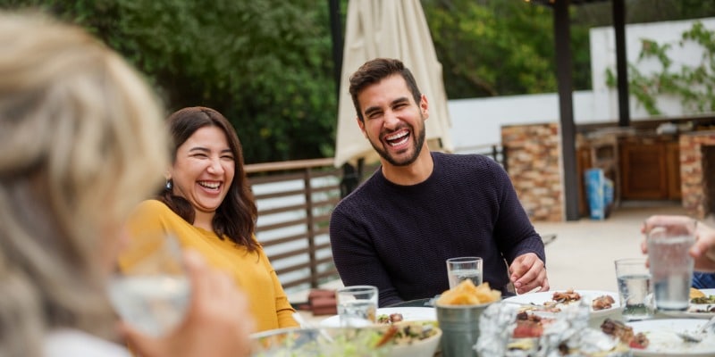 Family laughing around dinner table